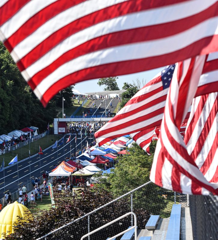 Flags wave atop the bleachers at Derby Downs as racers compete in the All-American Soap Box Derby, Saturday, July 20, 2024, in Akron, Ohio.