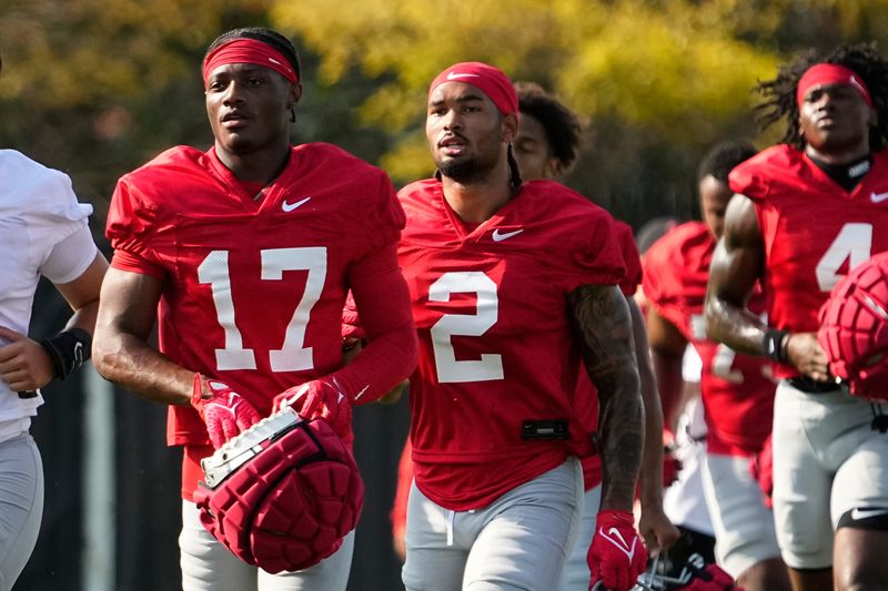 Aug 1, 2024; Columbus, OH, USA; Ohio State Buckeyes wide receivers Carnell Tate (17) and Emeka Egbuka (2) run between drills during football camp at the Woody Hayes Athletic Complex.