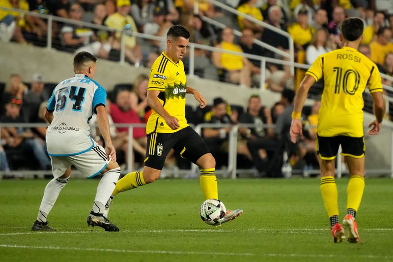 Aug 9, 2024; Columbus, OH, USA; Columbus Crew midfielder Dylan Chambost (7) dribbles past Sporting Kansas City midfielder Remi Walter (54) during the second half of the Leagues Cup soccer match at Lower.com Field. The Crew won 4-0.
