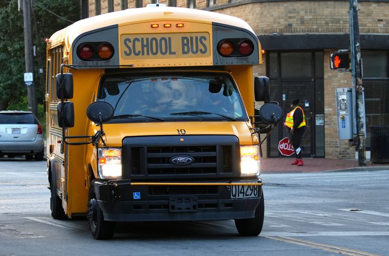 A school bus heads down Cedar Avenue in College Hill, on the first day school, Aug. 14, 2024.