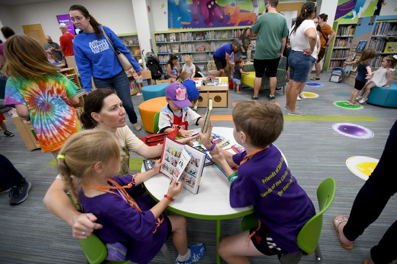 The Wallace family of Plain Township joins a celebration to reopen a renovated Stark County District Library Plain Community Branch. Saturday, August 17, 2024.