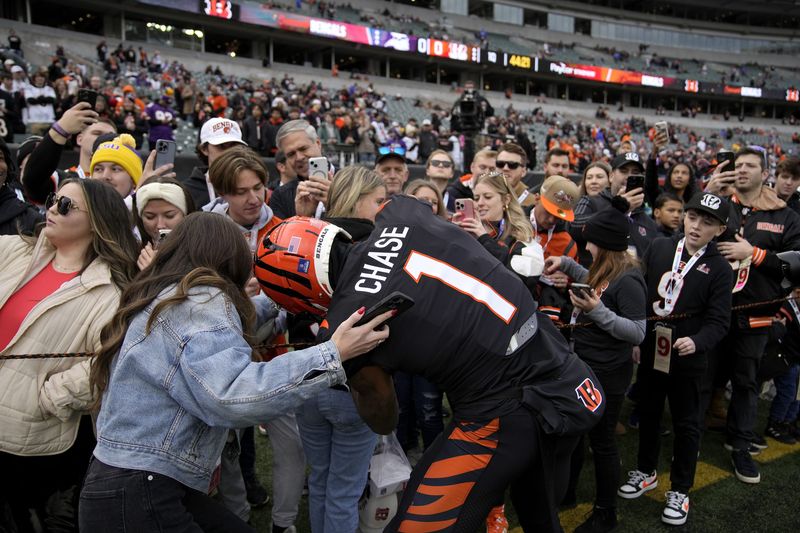 Cincinnati Bengals wide receiver Ja'Marr Chase (1) signs autographs for fans before the Bengals face the Minnesota Vikings at Paycor Stadium Saturday, December 16, 2023.