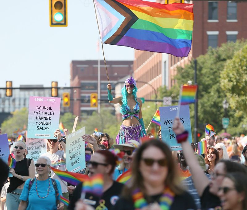 Marchers take part in the Akron PRIDE Festival and Equity March in Downtown Akron on Saturday Aug. 23.