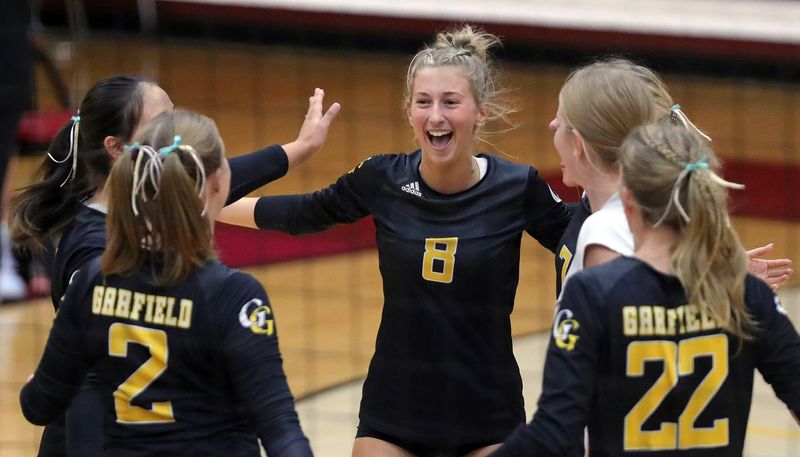 Garfield's Reese Shirkey, center, celebrates as Garfield leads during the first set of a high school volleyball match against Southeast, Thursday, Aug. 29, 2024, in Ravenna, Ohio.