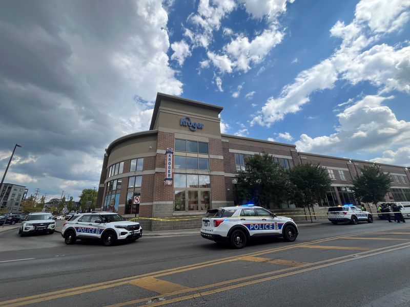 Columbus police officers secure the scene at a Kroger grocery store at 1350 N. High Street. Officers responded to a report of a fight between two men.