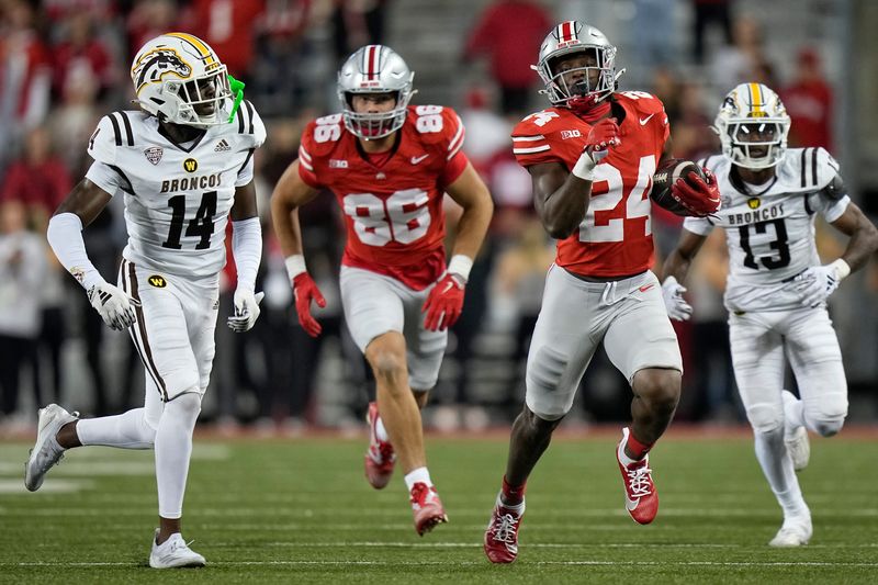 Sep 7, 2024; Columbus, Ohio, USA; Ohio State Buckeyes running back Sam Williams-Dixon (24) runs upfield past Western Michigan Broncos cornerback Lorenzo Williams Jr. (14) during the second half of the NCAA football game at Ohio Stadium.