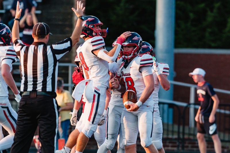 Indian Valley's Jaxon Burcher is congratulated by quarterback Ryker Williams after scoring a touchdown in a game against Dover, Friday, Sept. 15 at Crater Stadium, in Dover.