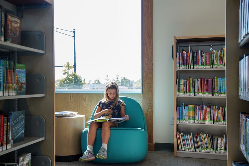 Lucy Frederick, 6, reads in the children’s area at the Forest Park Branch of the Cincinnati & Hamilton County Public Library.
