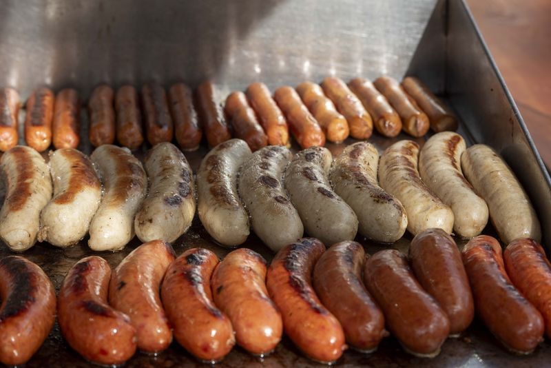 Sausages, hot dogs and bratwursts on the grill at Oktoberfest Zinzinnati 2024.