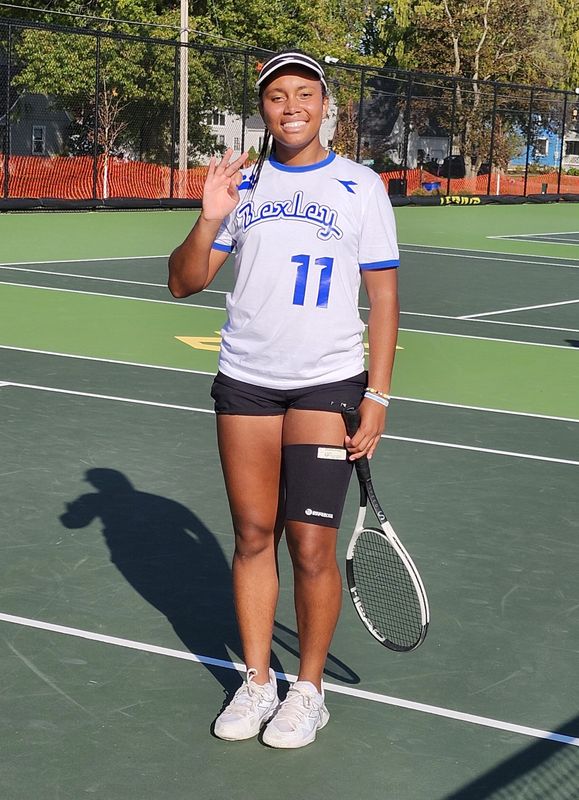 Bexley's Amiya Bowles holds up three fingers to signify winning her third consecutive Division II state singles championship in October 2024. Bowles will play for the school's boys team this spring to wrap up her high school career.