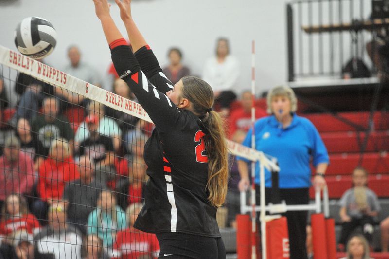 New London's Pailee Wilson blocks a ball at the net.