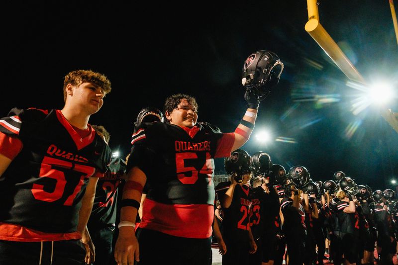 New Philadelphia celebrates their 42-24 win over Dover for the 121st annual Dover-Phila Football Game, Friday, Oct. 25, at Woody Hayes Quaker Stadium, in New Philadelphia. The Quakers won, 42-24.