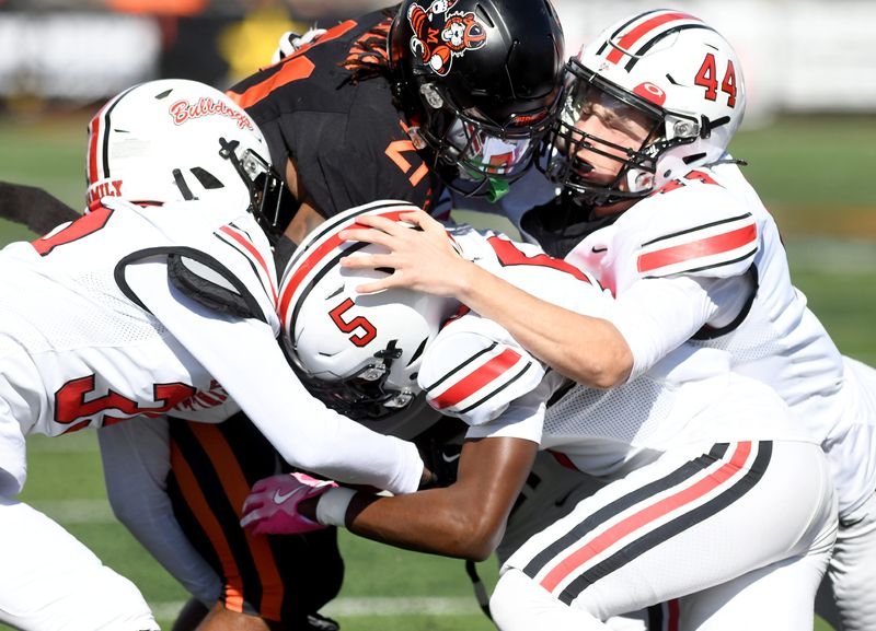 McKinley defenders Cortez Dorsey, Jordan McElroy and Collin Hinkle stop Massillon running back JaMeir Gamble in the first half of McKinley at Massillon football. Saturday, October 26, 2024.
