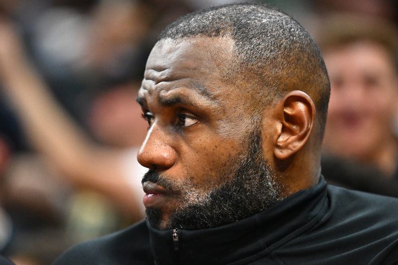 Lakers forward LeBron James watches from the bench during the fourth quarter of a 134-110 loss at the Cleveland Cavaliers, Oct. 30, 2024.