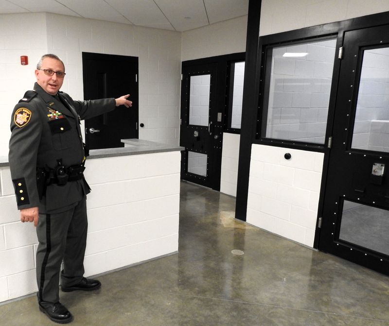 Lt. Chip Udischas, jail administrator, points out a holding cell in the booking section of the new Coshocton County Justice Center in this Tribune file photo.