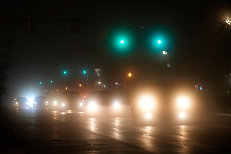 Cars drive through fog on High Street near the campus of Ohio State University in Columbus on Tuesday, Nov. 19, 2024. The area is under a dense fog advisory until mid morning.