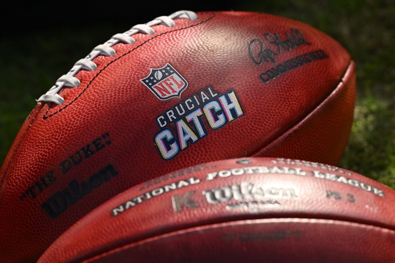 Oct 15, 2023; Chicago, Illinois, USA; A close-up view of footballs with the Crucial Catch logo during an NFL game between the Minnesota Vikings and the Chicago Bears at Soldier Field. Mandatory Credit: Jamie Sabau-USA TODAY Sports