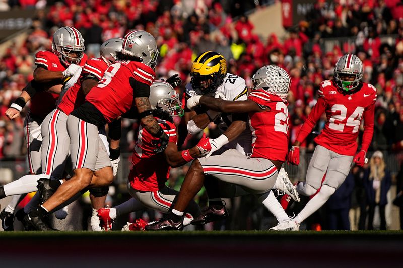 Ohio State Buckeyes linebacker Arvell Reese (20) tackles Michigan Wolverines running back Kalel Mullings (20) during the first half of the NCAA football game at Ohio Stadium in Columbus on Saturday, Nov. 30, 2024.