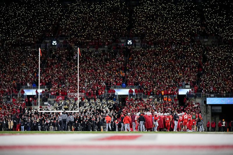 Fans light up the stands with cell phones during the first half of the College Football Playoff first round game between the Ohio State Buckeyes and the Tennessee Volunteers at Ohio Stadium in Columbus on Dec. 21, 2024.