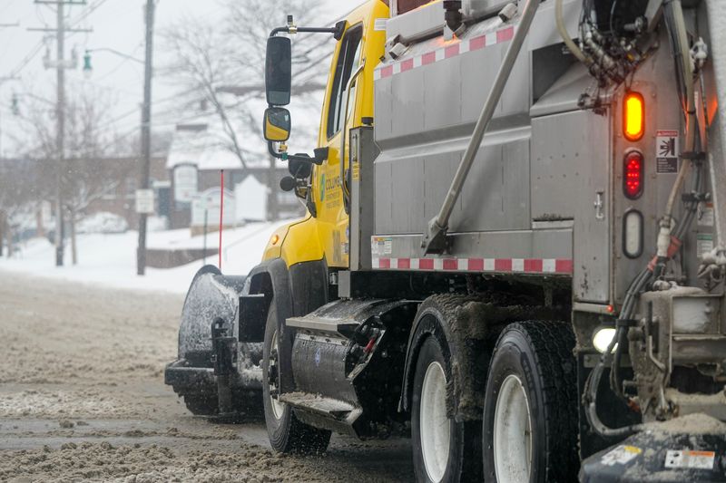 A City of Columbus snow plow hits North High Street in Clintonville as snow continues to fall in Columbus on Jan. 6, 2025.