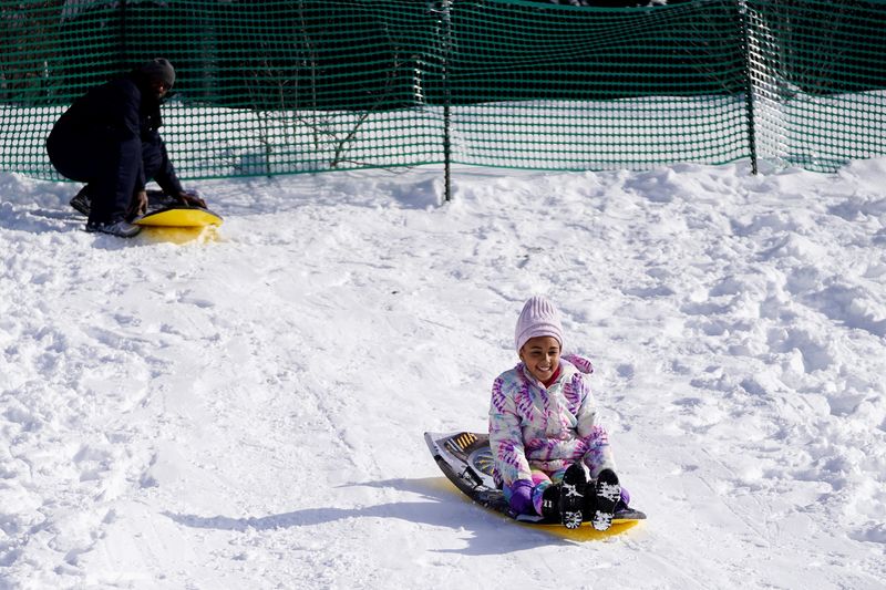 Jazmine Anderson, 10, sleds down a hill, Saturday, Jan. 11, 2025, at Ault Park in Hyde Park.