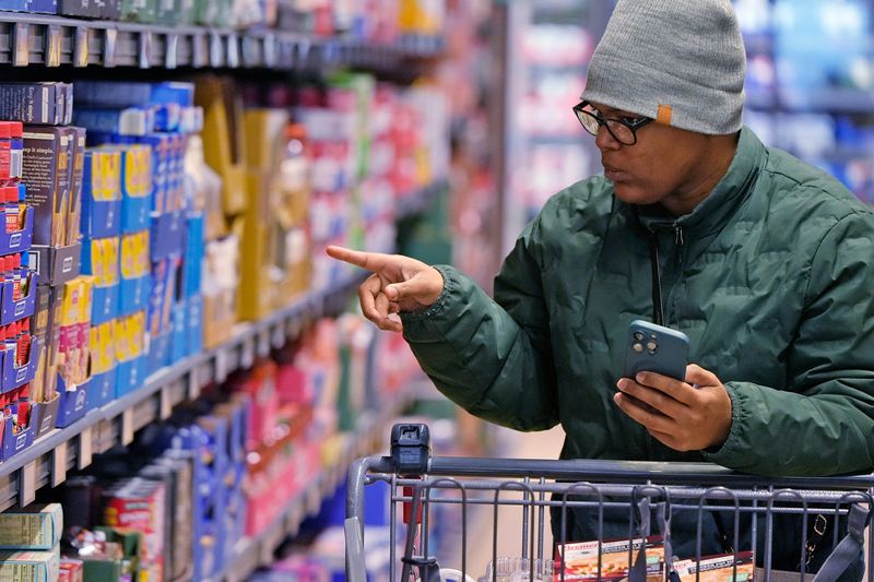 Jontayesha Brown searches through the products at the ALDI on Romig Road, one of several ALDI stores in Greater Akron.