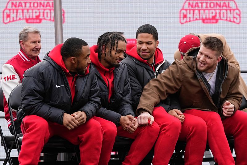 Ohio State Buckeyes captains, from left, TreVeyon Henderson, Emeka Egbuka, linebacker Cody Simon (0) and Jack Sawyer embrace during the Ohio State Buckeyes College Football Playoff National Championship celebration at Ohio Stadium in Columbus on Jan. 26, 2025.