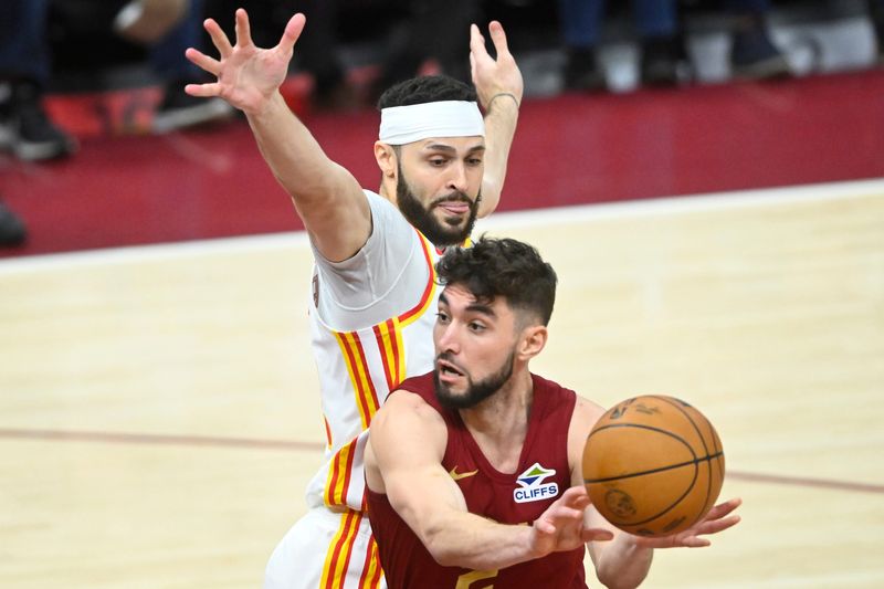 Cleveland Cavaliers guard Ty Jerome (2) throws a pass beside Atlanta Hawks forward Larry Nance Jr. (22) in the third quarter at Rocket Mortgage FieldHouse in Cleveland on Jan. 30, 2025.