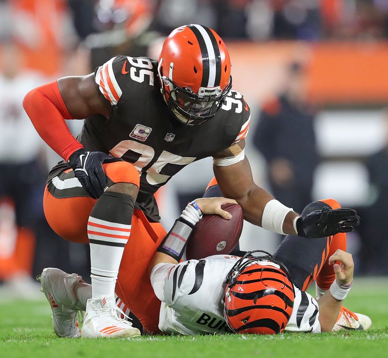 Cleveland Browns defensive end Myles Garrett (95) pats Cincinnati Bengals quarterback Joe Burrow (9) after sacking him Oct. 31, 2022, in Cleveland.