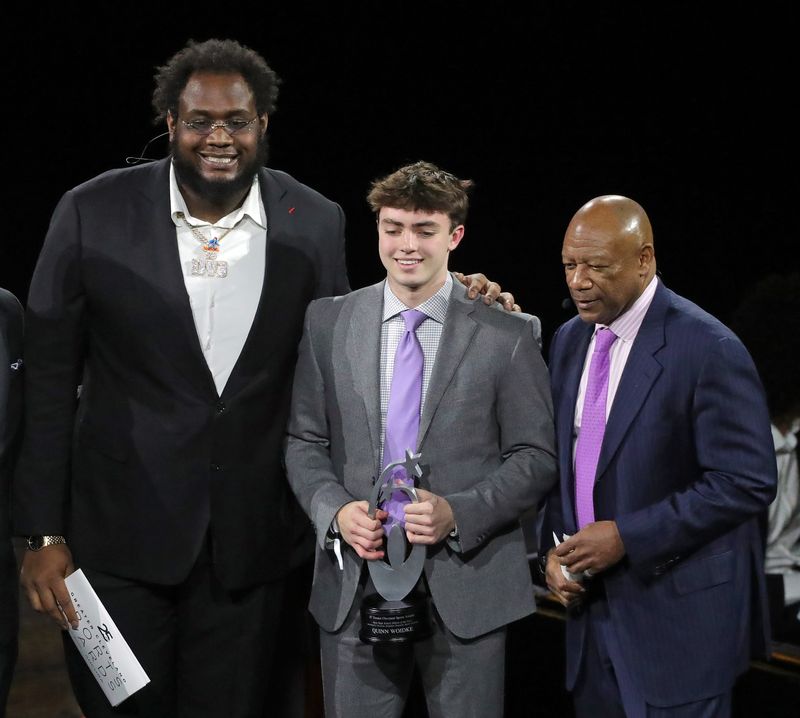 Cleveland Browns offensive lineman Dawand Jones, left, and Hanford Dixon, right, present St. Ignatius basketball player Quinn Woidke with the male athlete of the year award during the 25th Greater Cleveland Sports Awards at Rocket Mortgage FieldHouse on Thursday, Feb. 6, 2025, in Cleveland, Ohio.