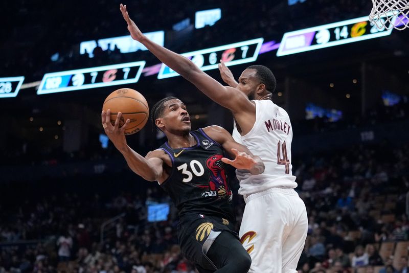 Feb 12, 2025; Toronto, Ontario, CAN; Cleveland Cavaliers forward Evan Mobley (4) defends against Toronto Raptors guard Ochai Agbaji (30) during the first half at Scotiabank Arena. Mandatory Credit: John E. Sokolowski-Imagn Images