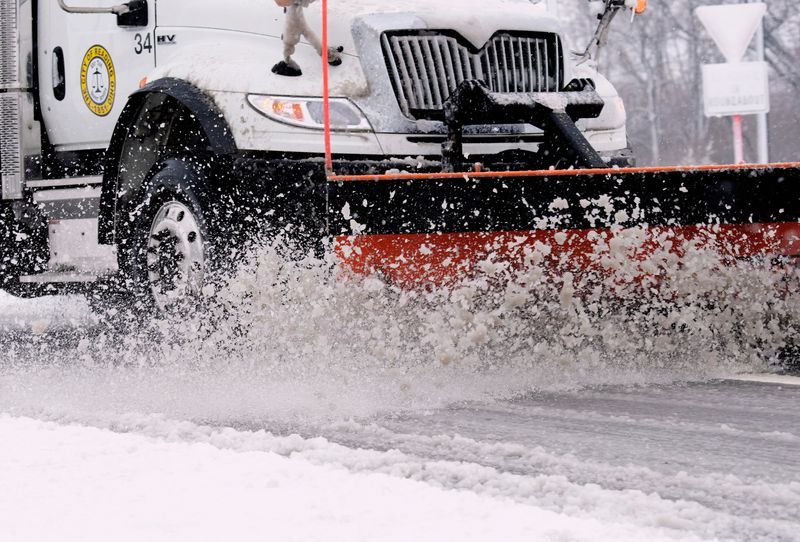 A plow from the city of Reading, heads down Hunt Road in Blue Ash, Sunday, Feb. 16, 2025. Overnight rains turned to snow across the region.