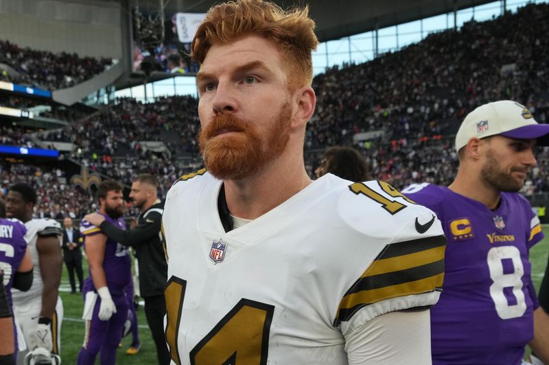 Oct 2, 2022; London, United Kingdom; New Orleans Saints quarterback Andy Dalton (14) walks off the field after an NFL International Series game against the Minnesota Vikings at Tottenham Hotspur Stadium. The Vikings defeated the Saints 28-25. Mandatory Credit: Kirby Lee-USA TODAY Sports