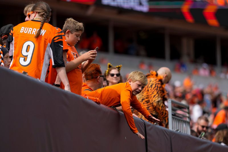 A young Bengals fan cheers before the first quarter of the NFL Week 1 game between the Cincinnati Bengals and the New England Patriots at Paycor Stadium in downtown Cincinnati on Sunday, Sept. 8, 2024.