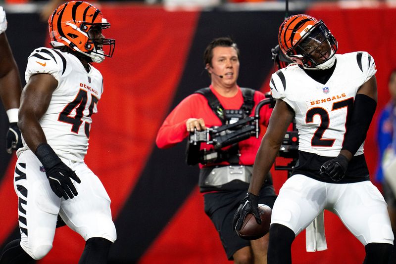 Cincinnati Bengals safety Jordan Battle (27) dances after scoring a touchdown on an interception in the first quarter of the NFL preseason game between the Cincinnati Bengals and the Indianapolis Colts at Paycor Stadium in Cincinnati on Thursday, Aug. 22, 2024.