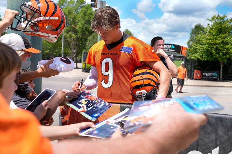 Bengals quarterback Joe Burrow signs autographs after OTAs Tuesday, May 28, 2024 at the Kettering Health Practice Fields outside of Paycor Stadium. Burrow along with several other Bengals players signed jerseys, footballs and other items for fans as they waited for the players to exit the practice field.