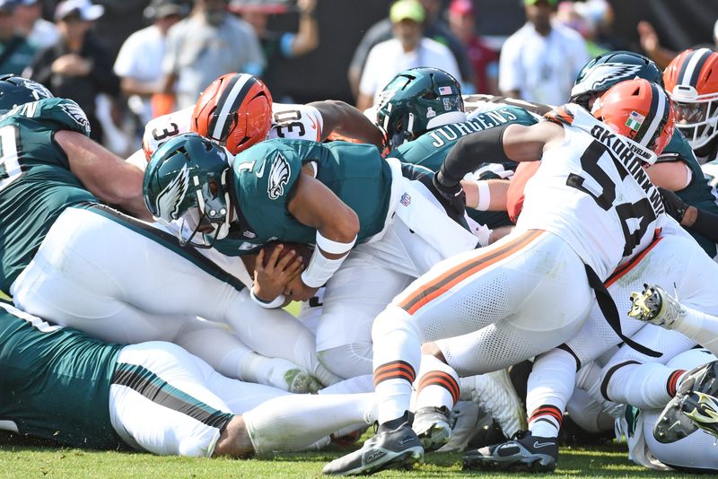Oct 13, 2024; Philadelphia, Pennsylvania, USA; Philadelphia Eagles quarterback Jalen Hurts (1) picks up a first down against the Cleveland Browns during the first quarter at Lincoln Financial Field. Mandatory Credit: Eric Hartline-Imagn Images