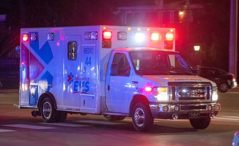 An ambulance drives toward a hospital, lights and sirens engaged, on Wednesday, Aug. 11, 2021, at the scene of an earlier shooting near the corner of 75th and N. Shadeland Ave., that reportedly resulted in at least one injury to a law enforcement officer, and possibly an unknown number of others.