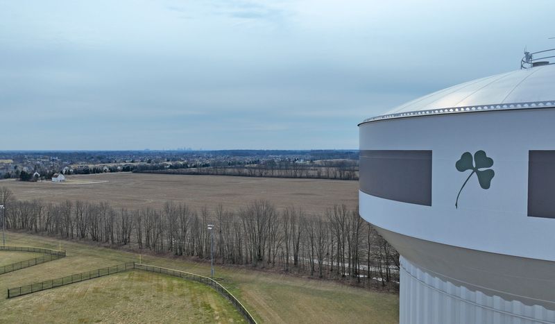 The Dublin shamrock logo is painted on a water tower near the Dublin West Innvovation District that is planned for the farm field behind the tower. Darree Fields, a Dublin city park, is in the foreground.