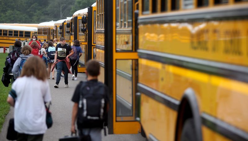 Students rush to their buses at the end of the school day at Tallmadge Middle School, Wednesday, Aug. 18, 2021, in Tallmadge, Ohio.