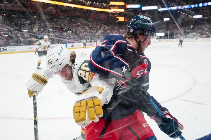 Columbus Blue Jackets defenseman Jake Christiansen (2) fights for the puck with Vegas Golden Knights left wing Brandon Saad (20) during the first period of the NHL hockey game at Nationwide Arena in Columbus on March 13, 2025.