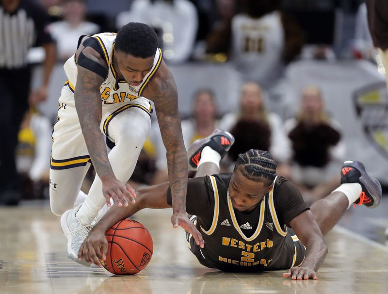Kent State's Cian Medley, left, and Western Michigan's Chansey Willis Jr. battle for a loose ball during a Mid-American Conference Tournament quarterfinal March 13, 2025, in Cleveland, Ohio.