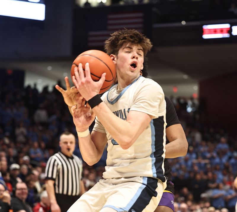 Louisville's Brayden Gross (2) grabs a rebound during the OHSAA Division III boys basketball state final game between Aiken and Louisville Friday, March 21, 2025, at the University of Dayton.