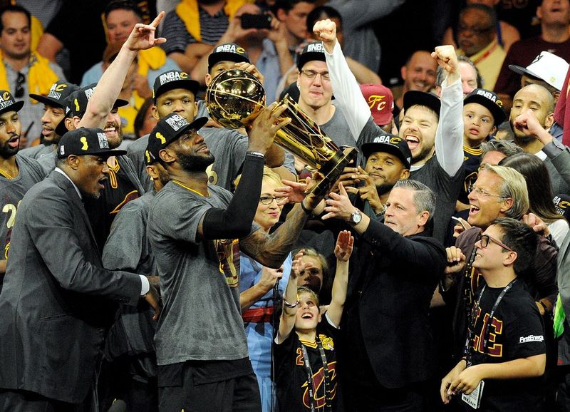Cleveland Cavaliers forward LeBron James celebrates with the Larry O'Brien Championship Trophy after the Cavs beat the Golden State Warriors in Game 7 of the 2016 NBA Finals on June 19, 2016, in Oakland, California.