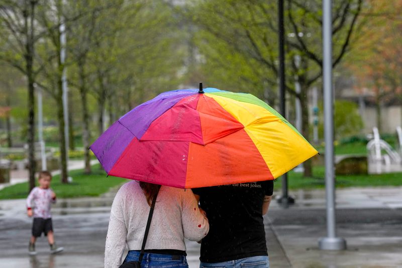 The rain didn't keep people from taking a walk Smale Riverfront Park in downtown Cincinnati Saturday, April 5, 2025.