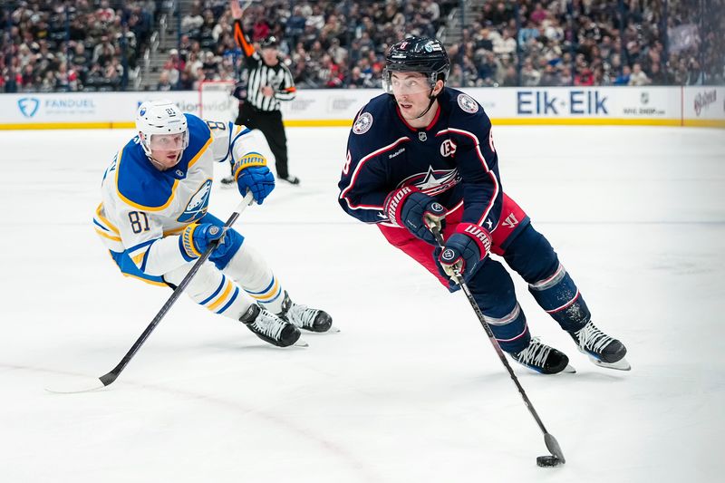 Blue Jackets defenseman Zach Werenski skates around Sabres center Sam Lafferty during Columbus' 3-2 win on April 10.