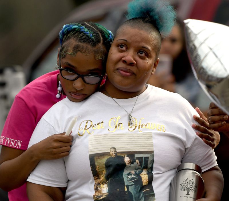 Jasmine Tyson is hugged by daughter Laniya Brown-Tyson during a vigil on April 18, 2025, for her uncle Frank Tyson to mark the one-year anniversary of his death.