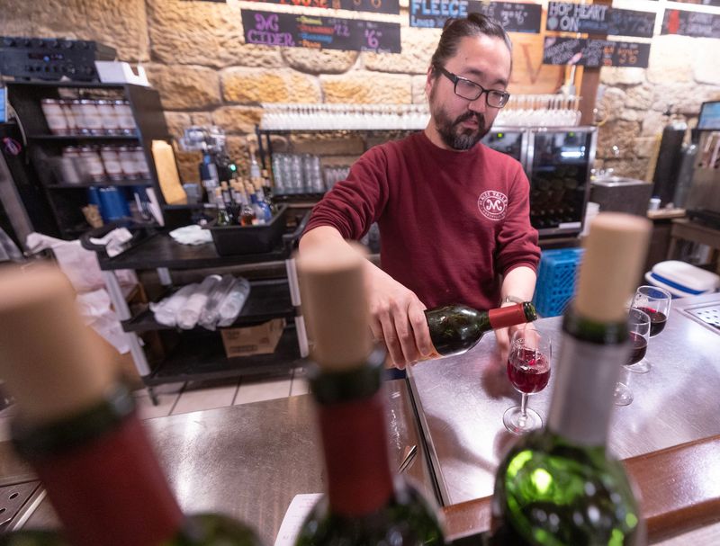 Jason Craig pours a glass of wine at Maize Valley Winery & Brewery in Marlboro Township. The winery is celebrating its 20th anniversary this year.