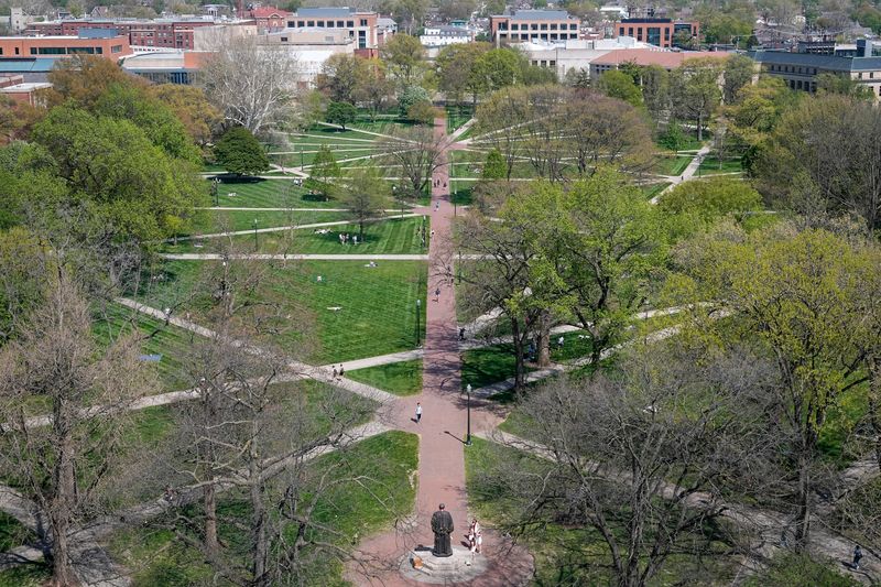Students hang out on the Oval on the campus of Ohio State University on April 25, 2025. With temperatures in the mid-80s, students flocked to the campus spot as they near the end of the school year.
