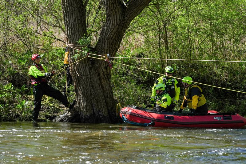 Zane Thomas, fire fighter and EMT from Charlestown Twp. And Carter Eugene Adams, Portage County Water Rescue, help Noah Wilson, fire fighter and paramedic from Aurora and Tom Eland, Lt. from Atwater. Jerry Richert, a corporate trainer with Dive Rescue International, led swift water rescue training with fire fighters and medics from multiple departments in different counties on the Cuyahoga River at Tannery Park in Kent on April 30.
